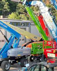 a group of cranes parked in front of a building