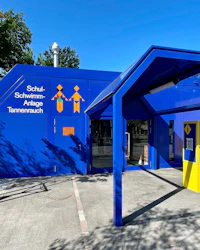 a blue building with a yellow sign on it